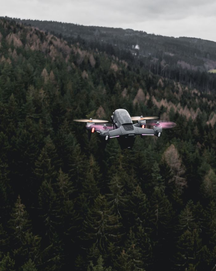 A drone flying over a lush forest in Ilmenau, Germany, captured from above.